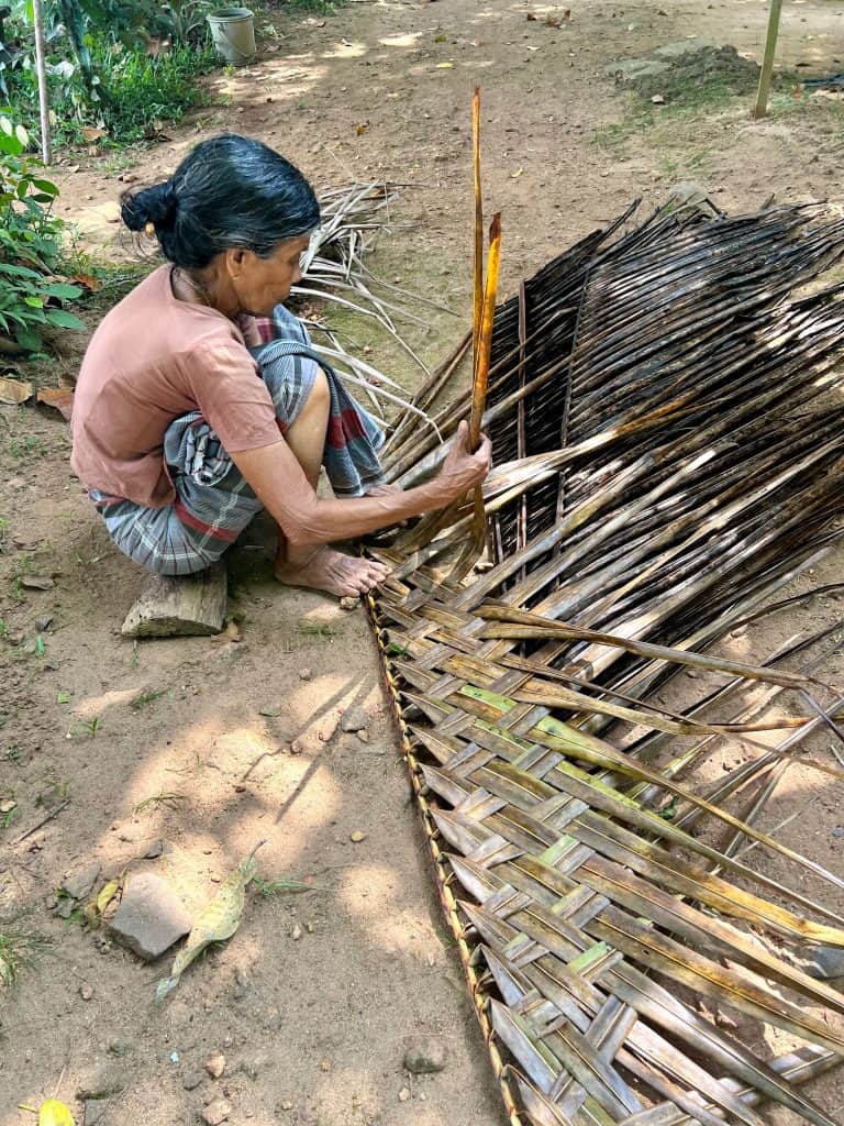 Kerala one of India's most eco-friendly states: Local lady making a thatched during a visit to Back to village: Showing why Kerala is one of India's friendly states