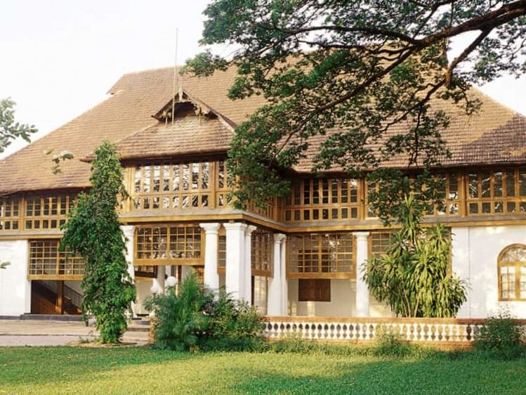Bolgatty Palace Island Resort exterior ehite washed colonial building with pillars and brown windows