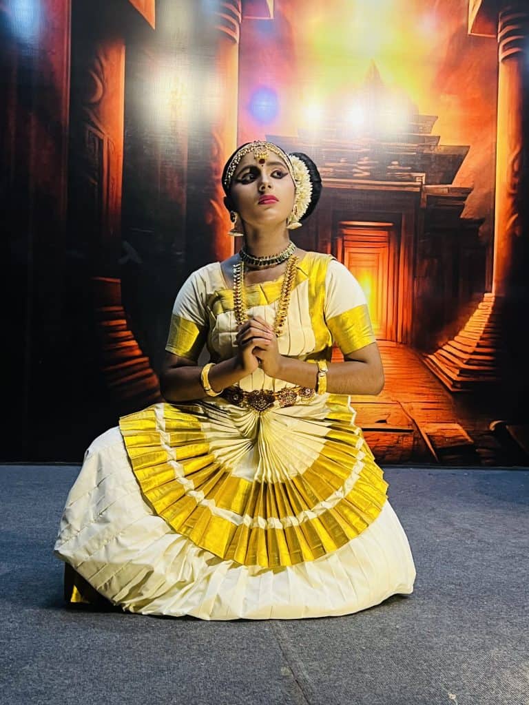 A female Kathakali dancer dressed in formal Mohiniyatram dress dancing at the Mudra Cultural Centre in Thekkady, Kerala