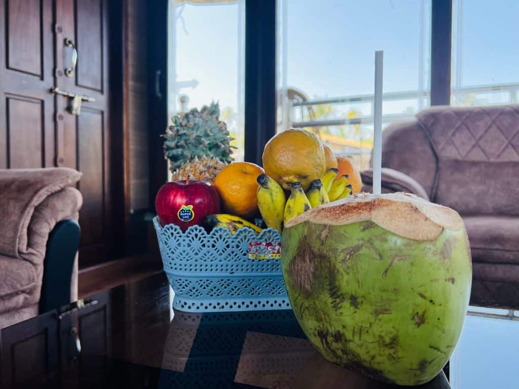 Beautiful Kerala backwaters: Basket of fruit and coconut in the living room of the Pickadly houseboat. 