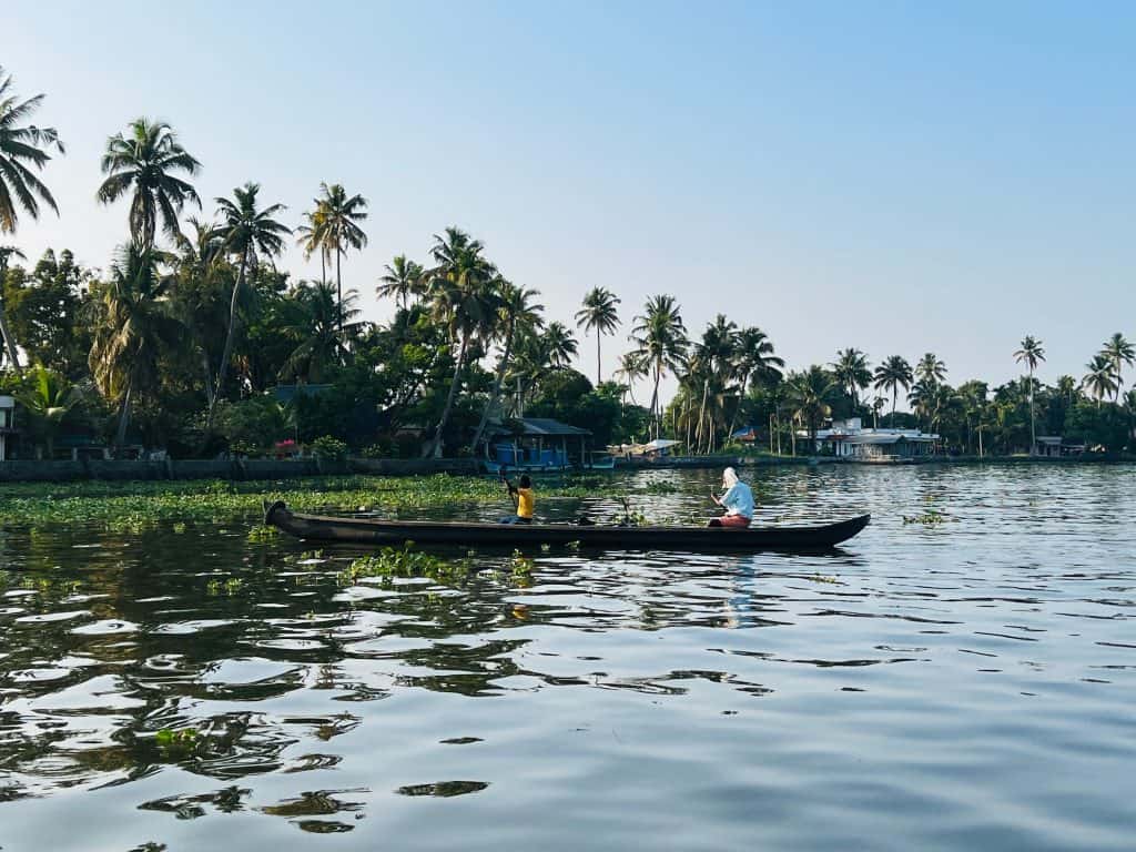 Canoe gliding down the larger backwater canal with 2 fishermen