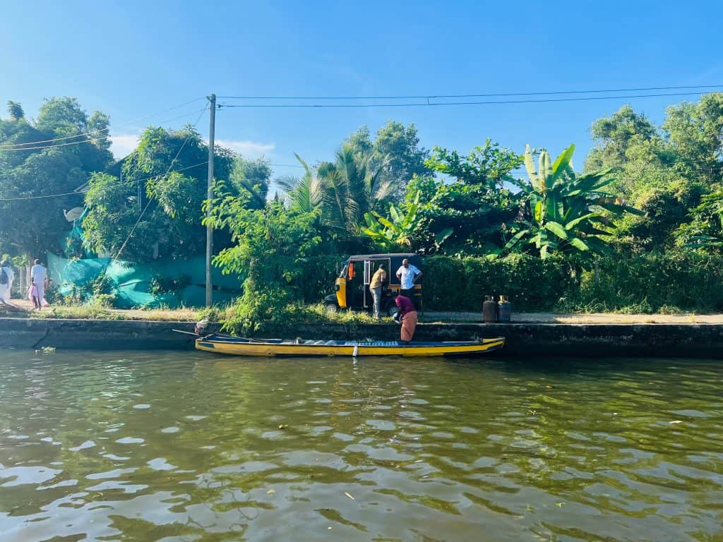 Locals queuing for a rickshaw on the banks of the backwaters near Alleppey