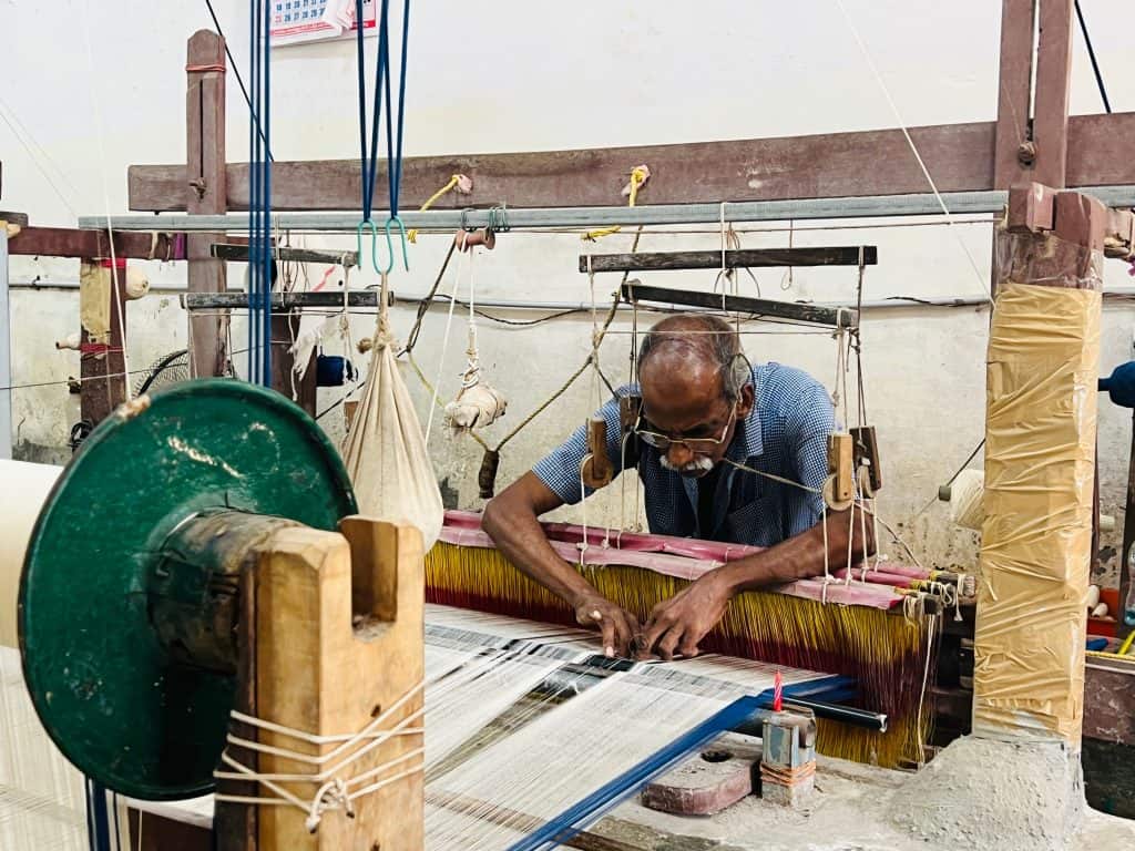 Men weaving sarees at the showrooms in Alleppey