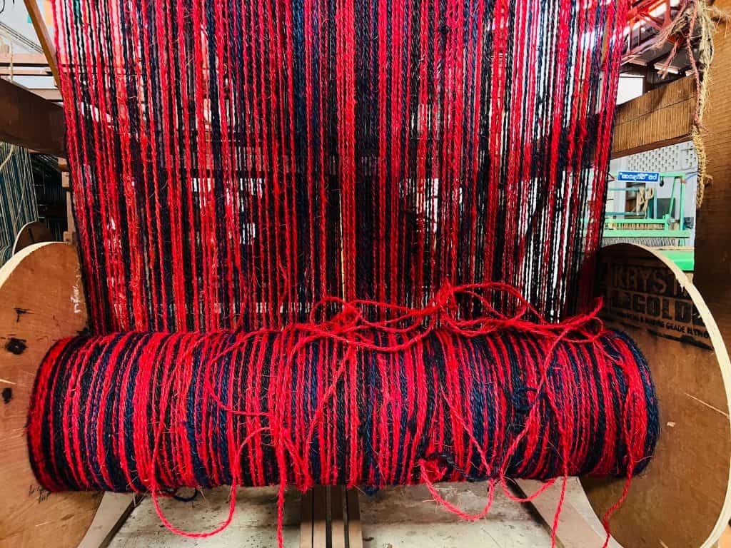 Pink and purple coir thread on a large bobbin at the International Coir Museum
