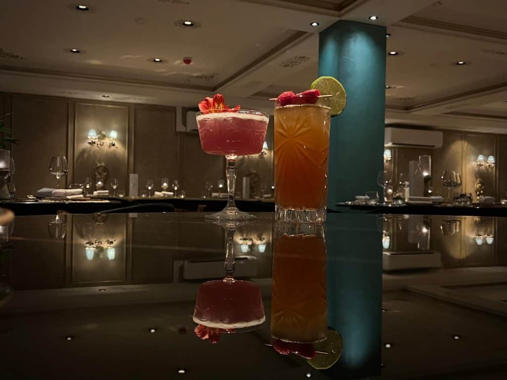 Indian Fine Dining At Varanasi.  he lavender garden Martini and dark & stormy cockatil on a black table with a reflection on the table at Varanasi, Leicester