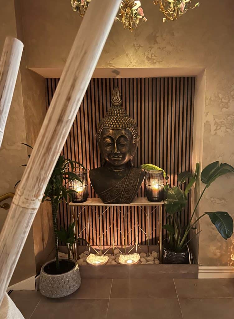 Indian Fine Dining At Varanasi. Buddha head on console table with lanterns abd flickering lights at Varanasi.