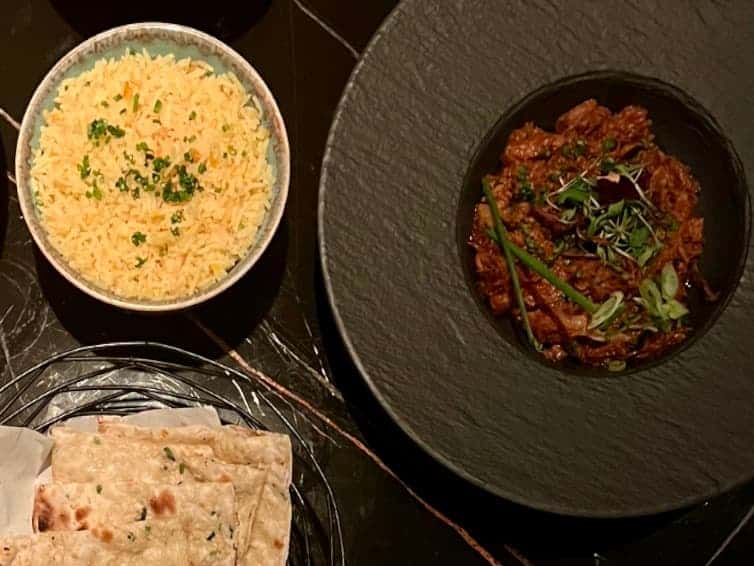 Indian fine dining at Varanasi:top lay of shredded lamb, garlic lamb and pilau rice at Varanasi Leicester