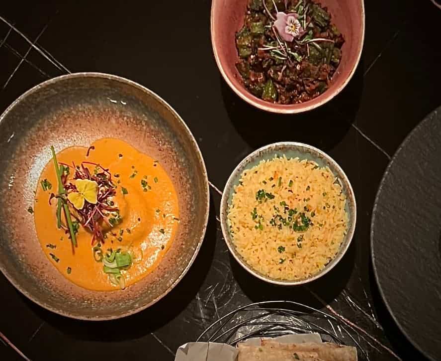 Indian fine dining at Varanasi: Top lay at Varanasi Leicester of main courses of Nizami kofta curry, achari okra and pilau rice