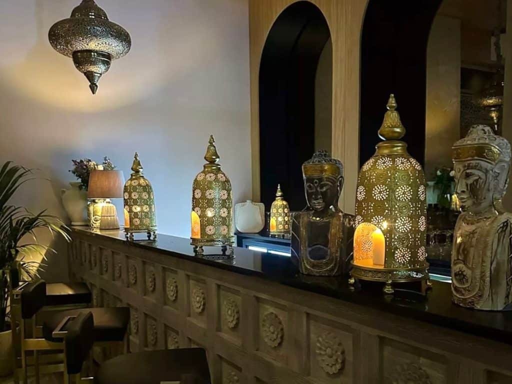 The atmospheric bar area at Varanasi in Leicester with counter top lanterns and flickering candles