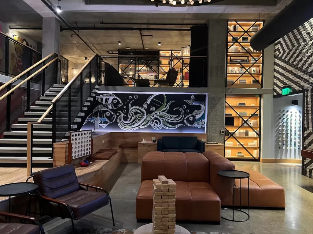 Moxy lobby area with brown leather sofas and side tables