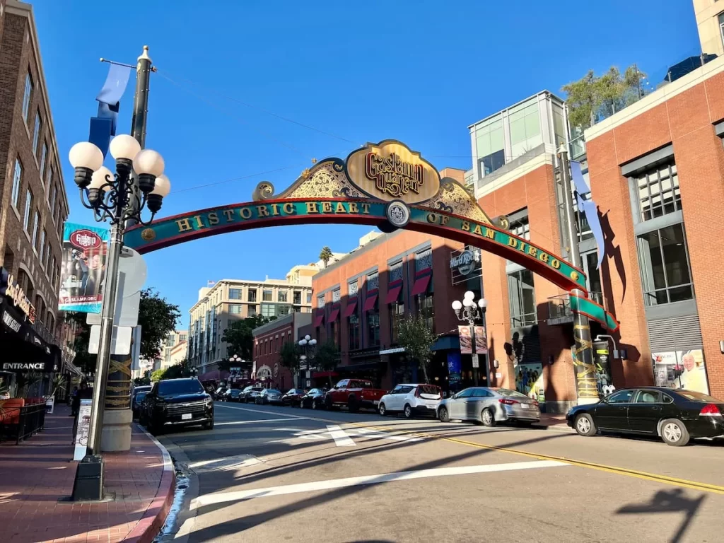 The Gaslamp District Archway sign with cars parked either side
