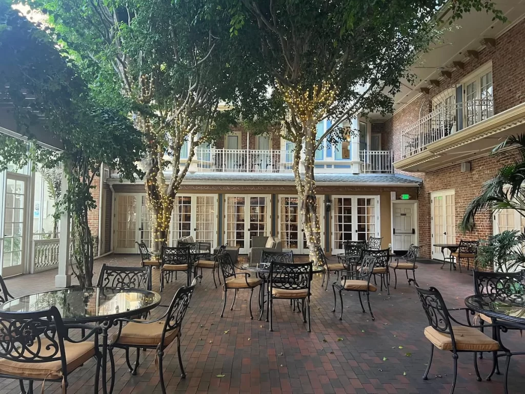 Courtyard of the Horton Grand Hotel, San Diego, featuring trees and fairy lights in a Victorian-style setting