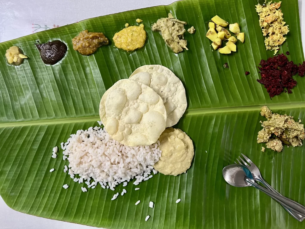 A banana leaf with small portions of traditional vegetarian food at Mr Suresh's house in Viakom