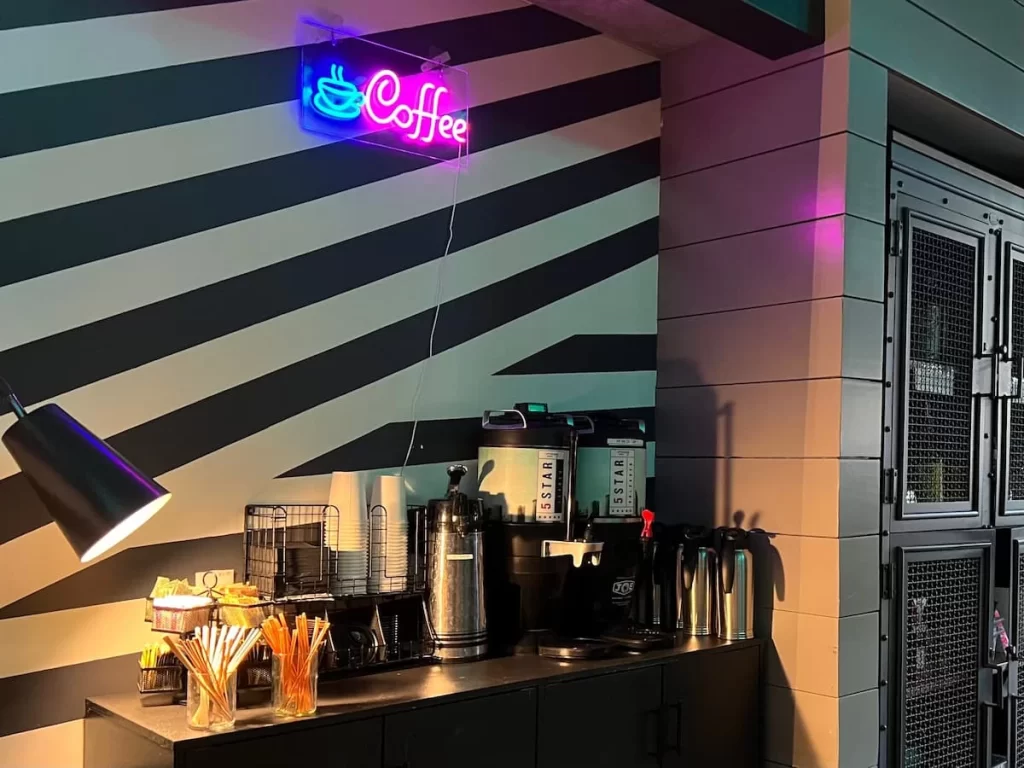 The neon signed complimentary coffee station at Moxy San Diego
