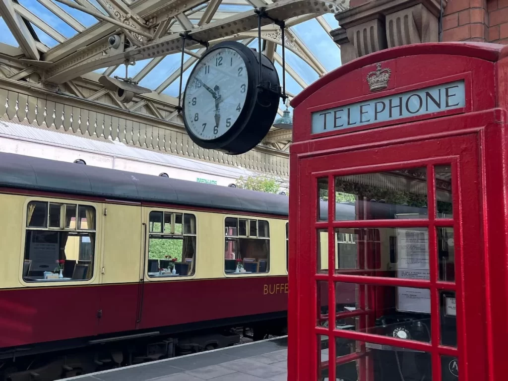Dining on the Great Central Railway: Red telephone box and carriage on the platform at Loughborough Central Station