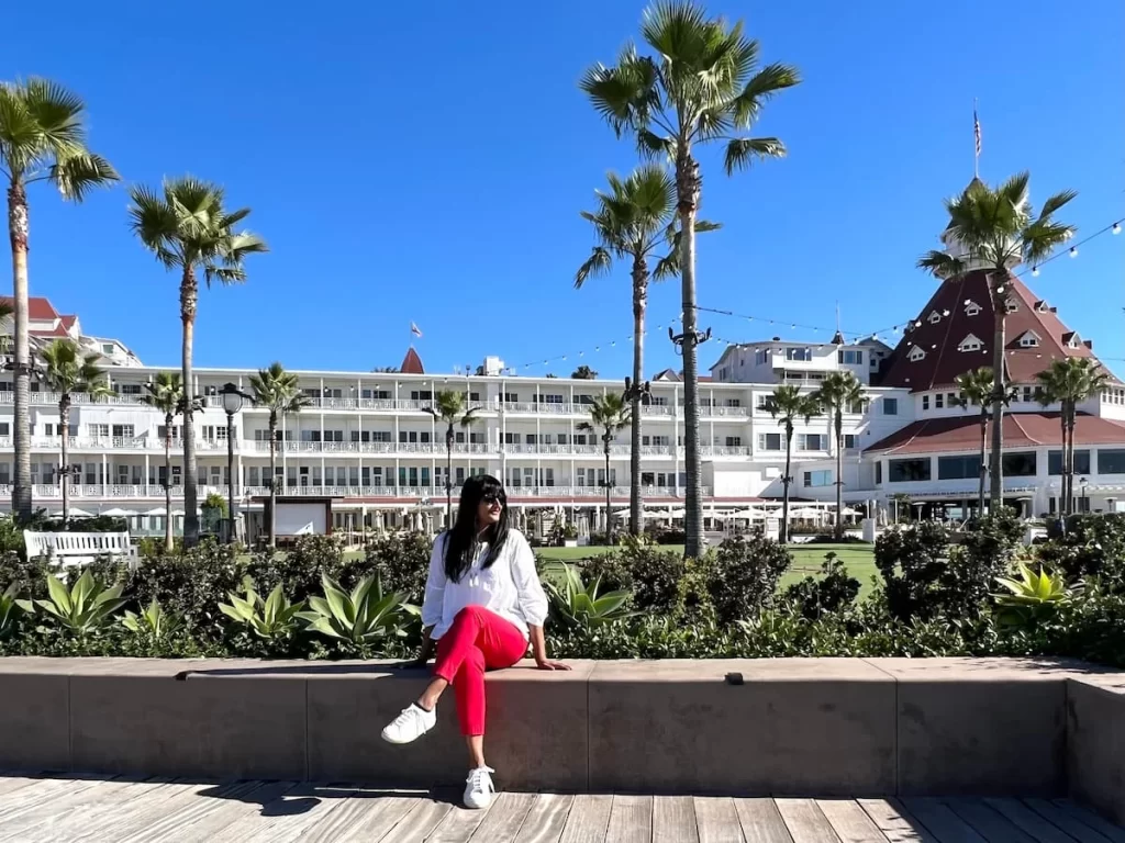 Bejal sitting along wall infront of Hotel del Coronado