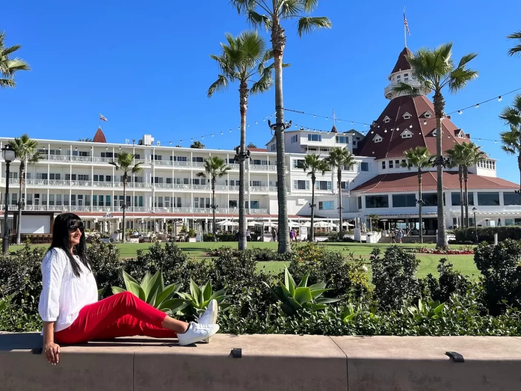 Bejal sitting along wall infront of Hotel del Coronado