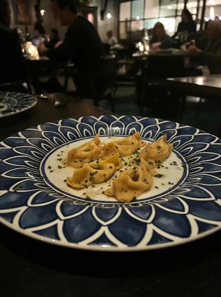 Scarpinocc with brown butter, feta, caramelised onion, 50 year old aged whiskey. at Herb & Wood, San Diego