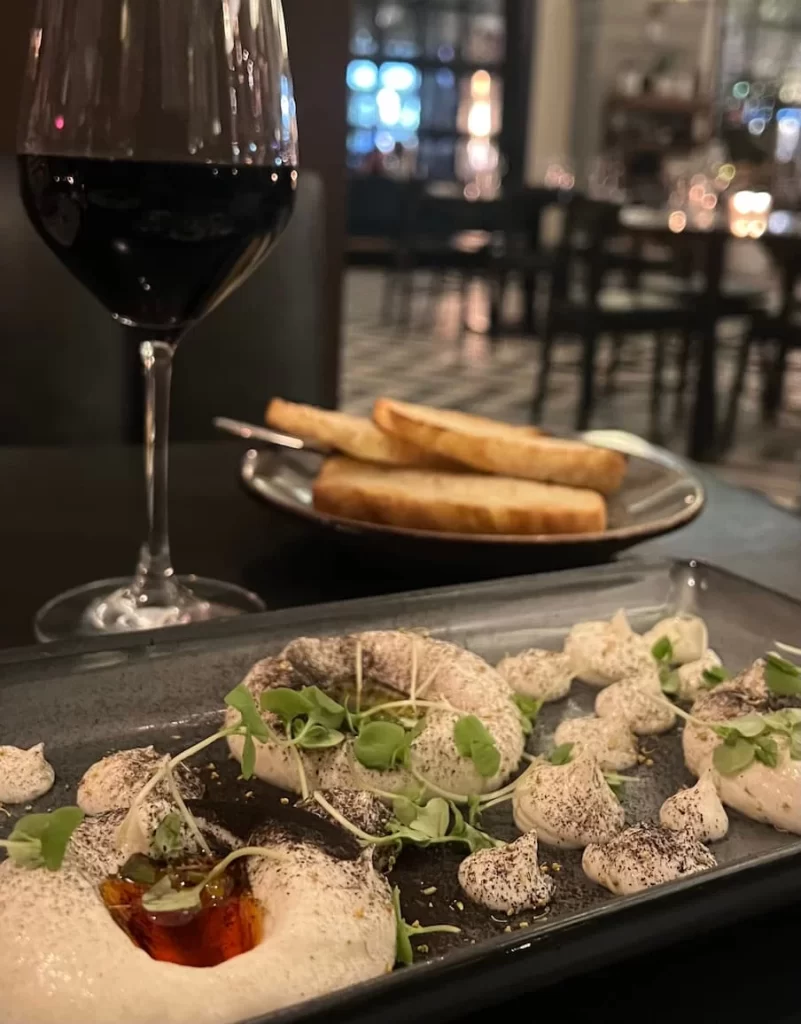 Meyer Lemon Ricotta with California Honey, Chili Oil, Lemon Oil, Fennel Pollen, House-Made Focaccia at Provisiobal Kitchen. San Diego