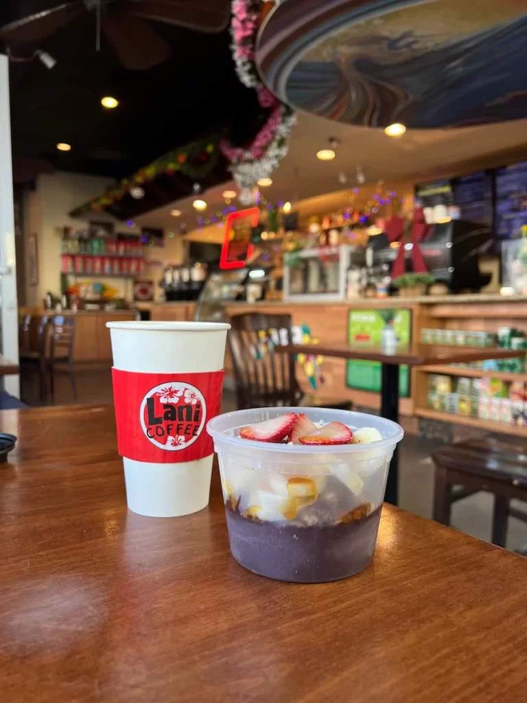 The coconut latte and acai bowl at Lani Coffee, San Diego with the counter and coffee shop in the background