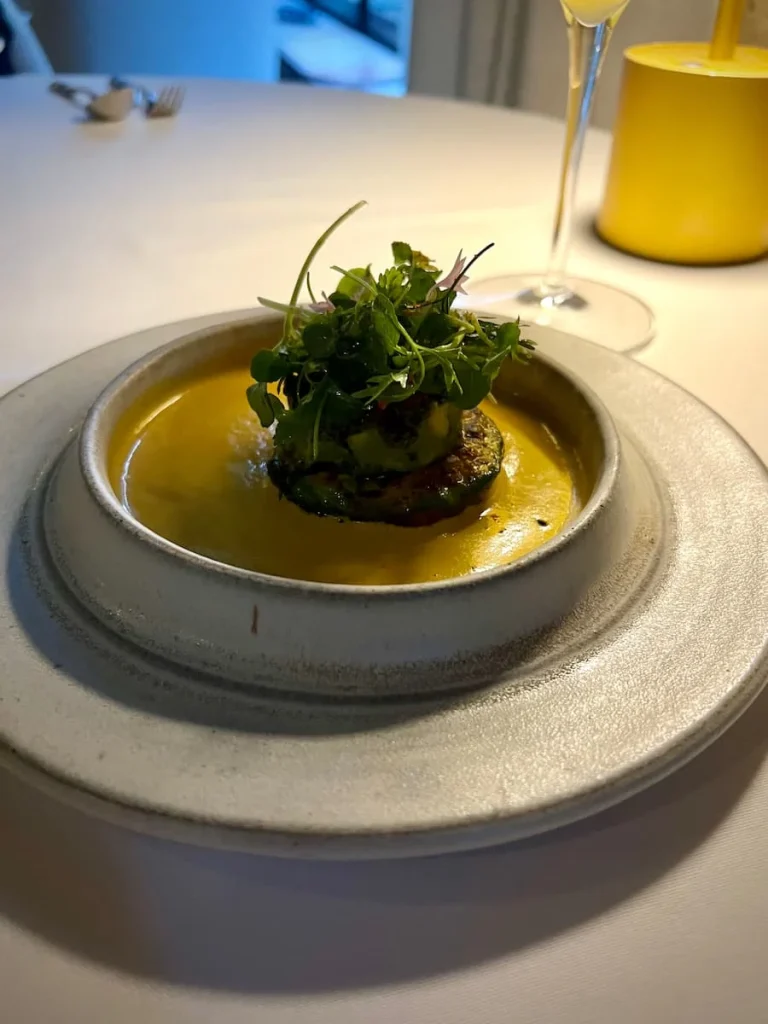 Avocado Kebab with green herbs in a low bowl at Indienne, Chicago