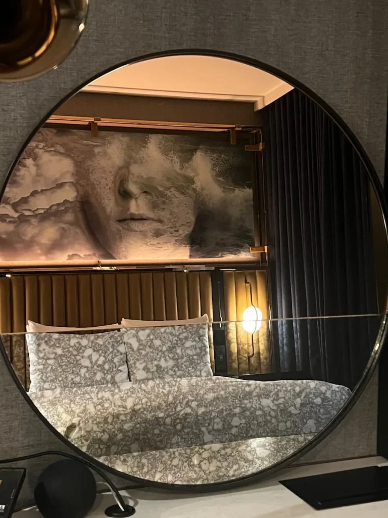 Reflection of the bed in the queen room through the mirror at Hotel EMC2, which is one of the cool and quirky hotels in Chicago