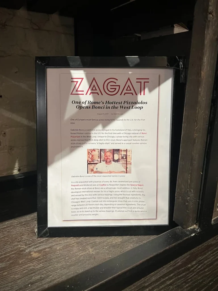 A framed press release at Bonci Pizzeria in Chicago with Gabriele Bonci's opening in Chicago, USA
