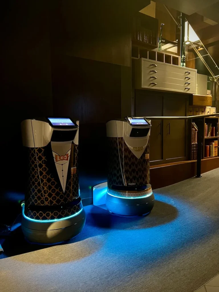 Cleo and Leo the hotel room service robots stationary in Hotel EMC2 lobby area, one of the cool and quirky boutique hotels in Chicago