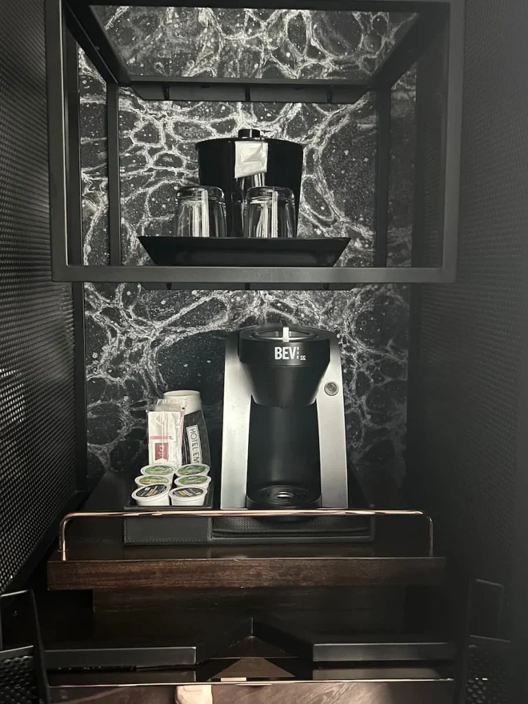 Coffee machine and drinks station with an ice bucket in the queen room at Hotel EMC2, one of the cool and quirky boutique hotels in Chicago