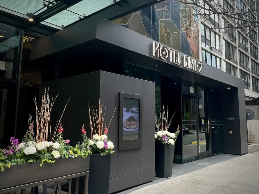 Exterior of the Hotel ECM2 showing the Albert seating and floral displays, one of the cool and quirky boutique hotels in Chicago