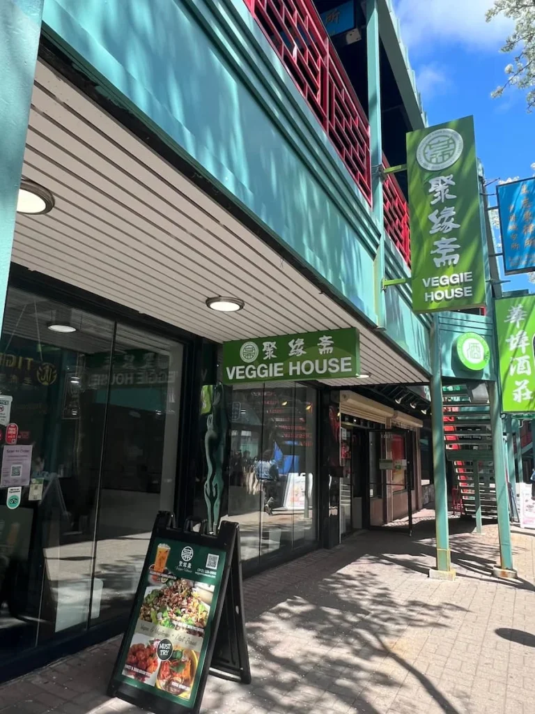 Exterior of Veggie House with green signage in Chinatown, Chicago