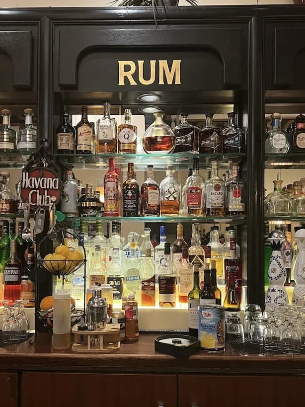 Havana Grill wooden bar with spirit bottles on the bar front, one of the places with vegetarian friendly food in Chicago