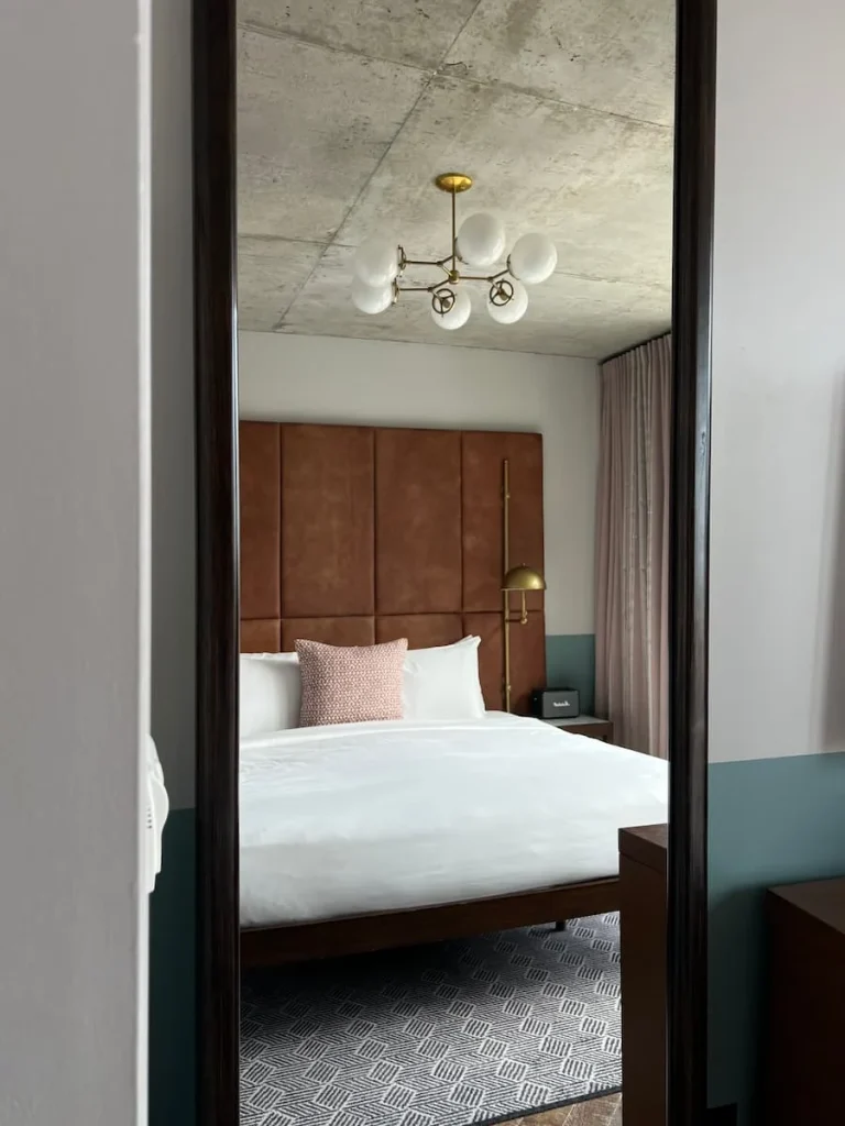 Cool and Unique hotels in Chicago, reflection of guest room bed in mirror at Hoxton