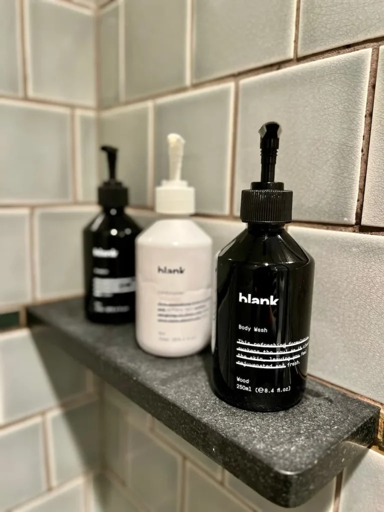 Blank bath producst in the shower at The Hoxton, Chicago