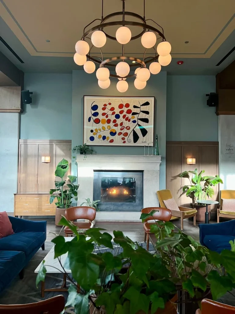 The Hoxton, Chicago lobby with fireplace adn circular light fitting