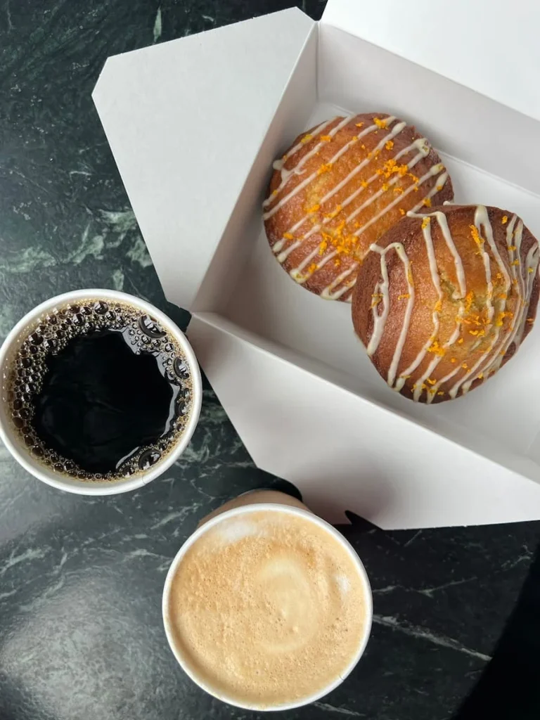 Top lay of orange tea cakes with coffee and cappuccino from Cafe Cira, The Hoxton, Chicago