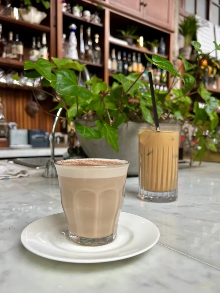 Chai latte and iced coffee on counter at Allis at Soho House, Chicago