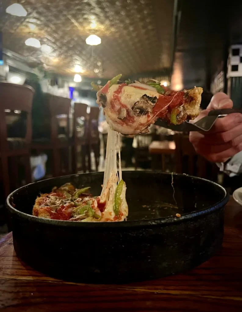 Cheese pull of the Deep Dish pizza at Pizzeria Uno, Chicago