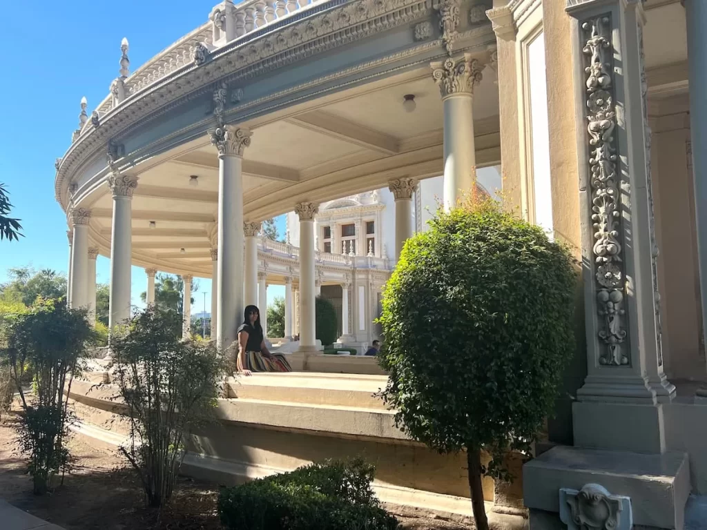 Visitors Guide to San Diego: the Gardens at Balboa Park with Bejal sitting in the Pergola