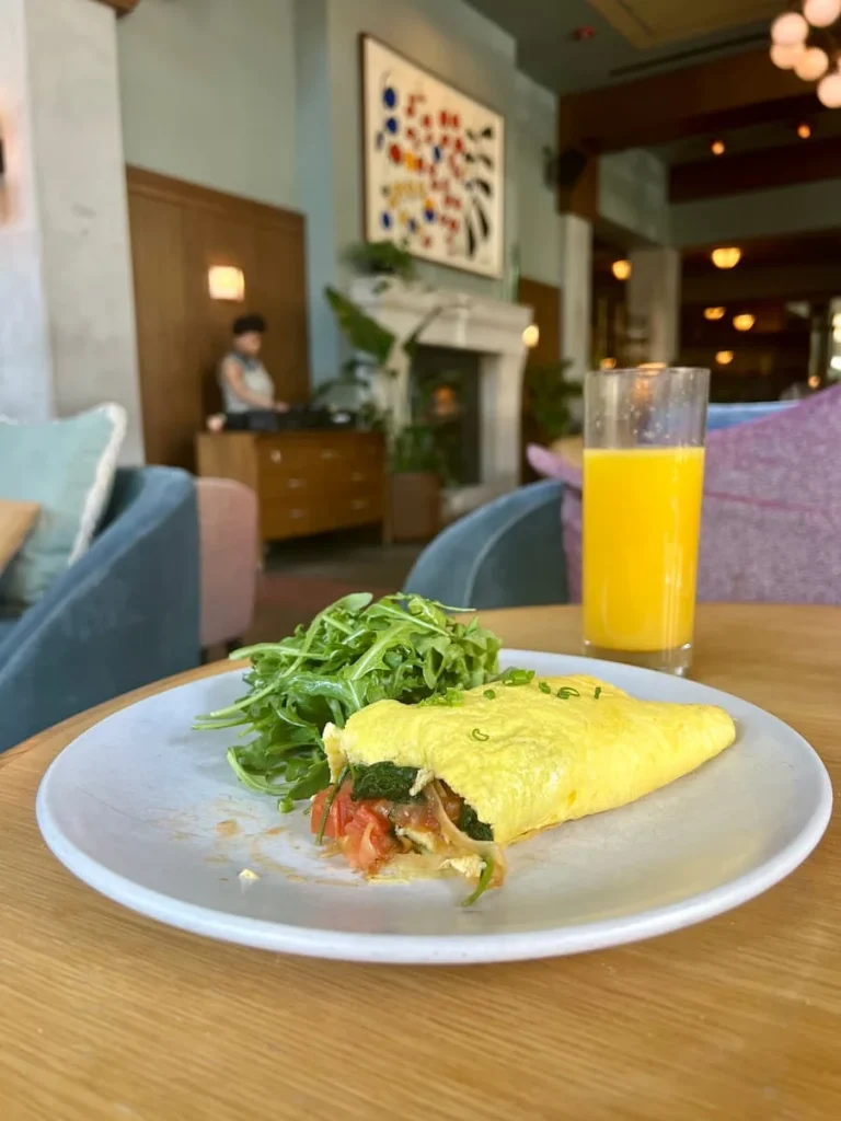 Omelette with salad and a DJ in the distance at Cira, The Hoxton, Chicago