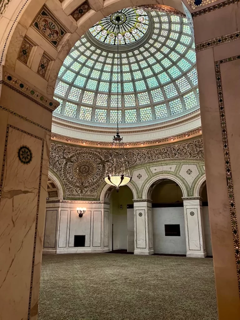 Photo locations in Chicago: world's largest Tiffany dome with mint blues and gold and a light piece hanging down. 