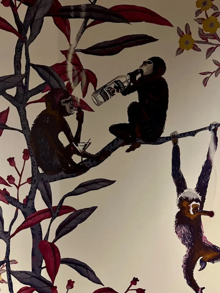 Monkey wallpaper in the communal loos at Moxy, Chicago, with monkeys smoking and drinking alcohol