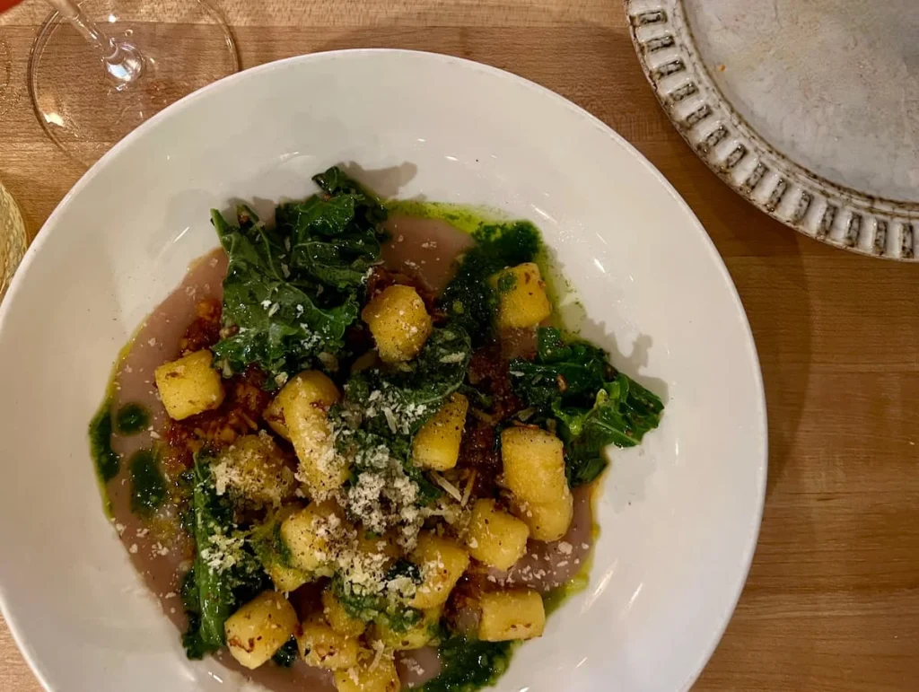 Yuca Gnocchi with toasted Yuca, parsnip puree, mushroom sofrito and kale at Bloom Plant-Based Kitchen, Chicago