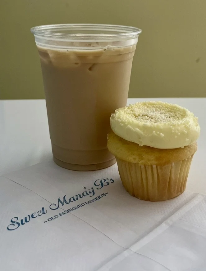 Side image of an iced latte and a lemon and vanilla cupcake at Sweet Mandy B's in Streeterville, Chicago