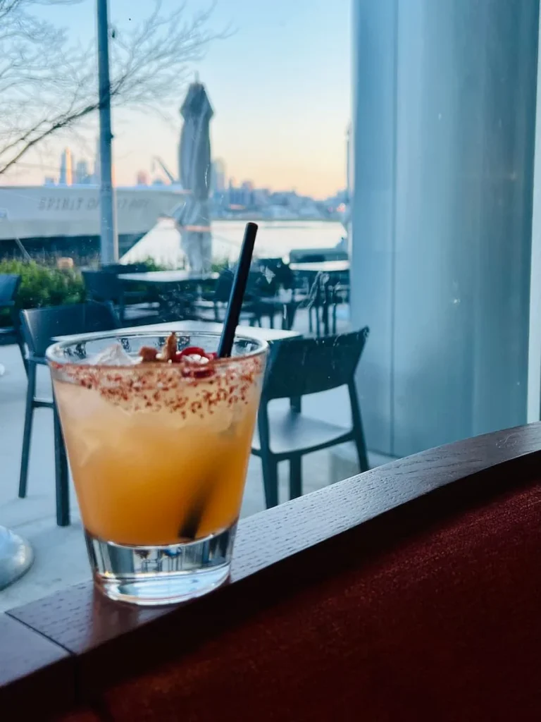 Spicy Pineapple Fresno cocktail at Lirica, Chicago with Navy Pier in the background
