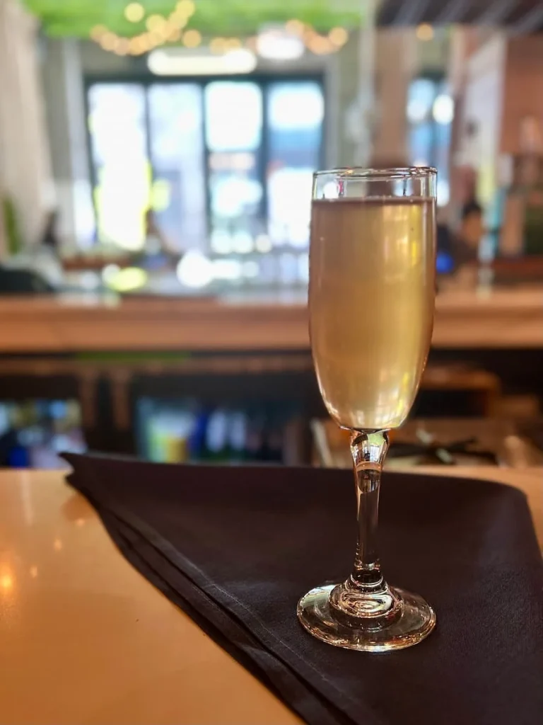 Zero-proof sparkling rose on the bar top at the Hampton Social Club, Chicago.One of the places that serves vegetarian-friendly food in Chicago