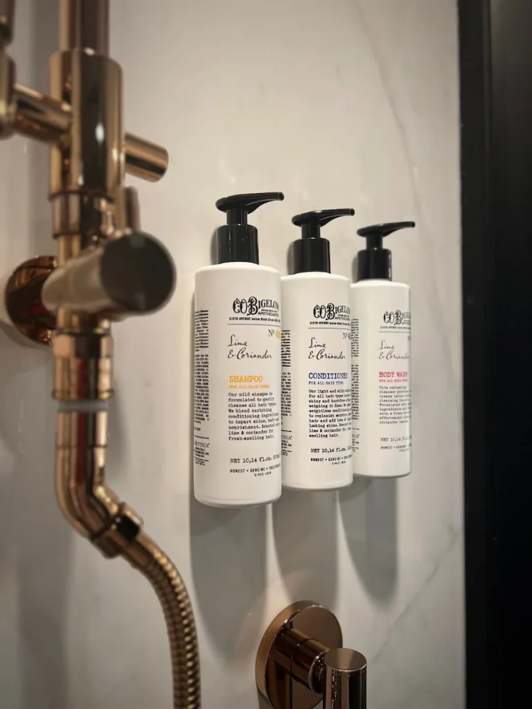 Bigelow full size bath products in the shower cubicle with gold accents in the queen bedroom at Hotel EMC2, one of the cool and quirky boutique hotels in Chicago