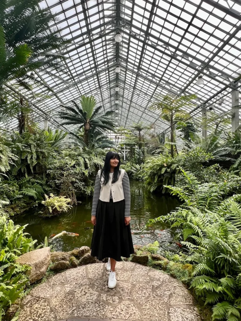 Bejal standing on a stone in the tropical greenhouse at Garfield Park Conservatory, Chicago