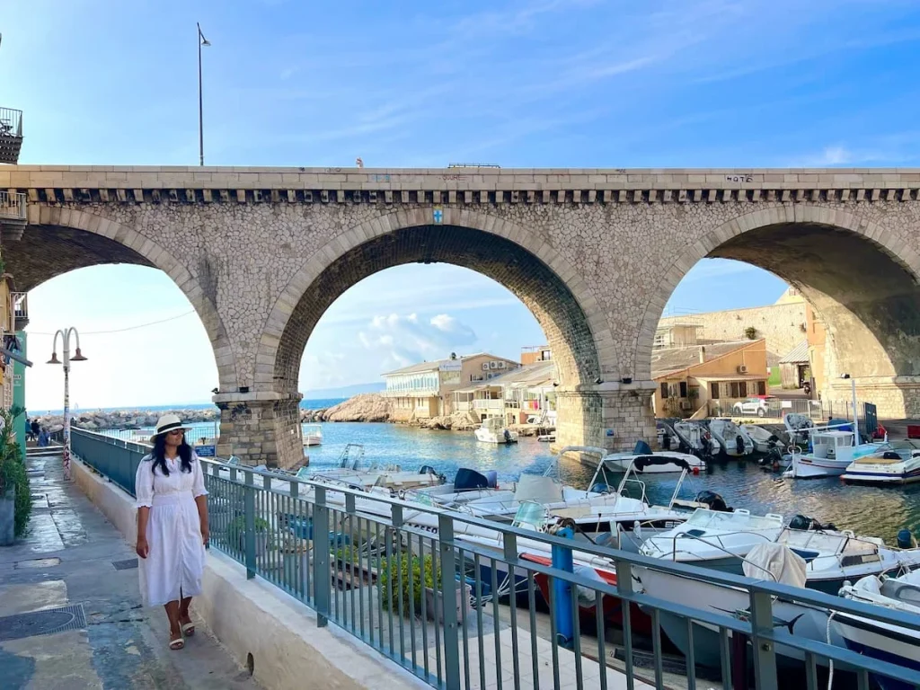One day in Marseille: Les Vallon des Auffes with Bejal standing at the side of the three arches in 