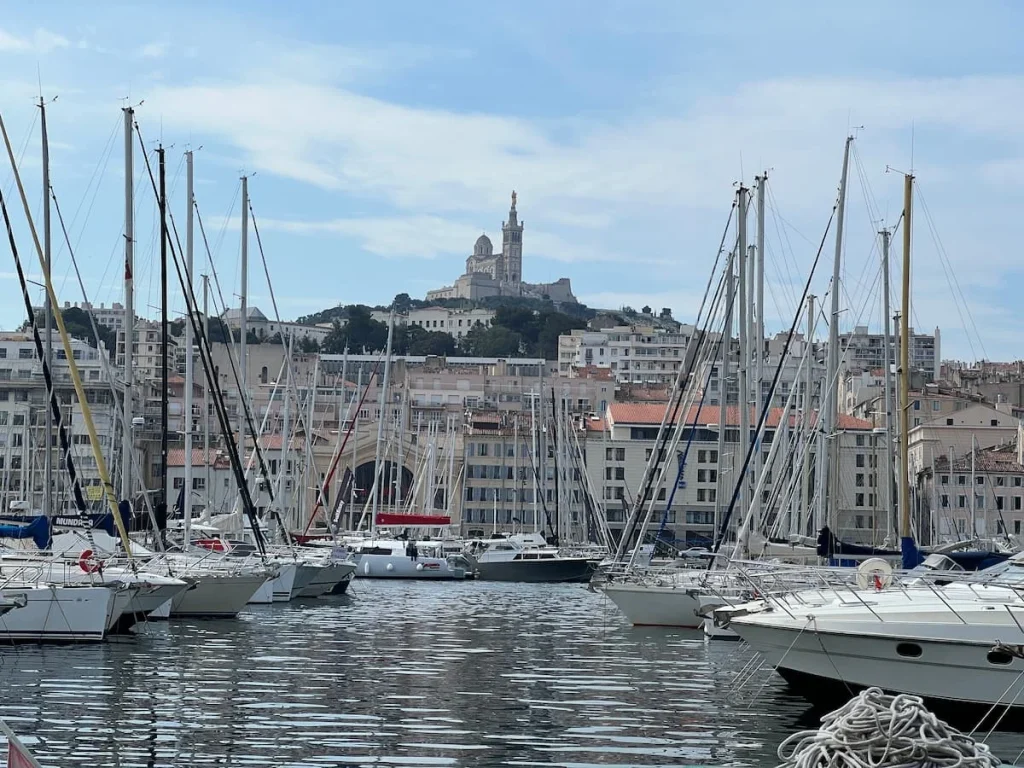The Vieux Port with yachts and the Notre Dame du Gard on the hill, Marseille